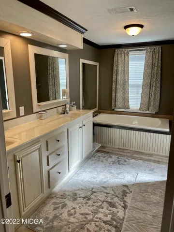 a bathroom with a sink a mirror and a bathtub