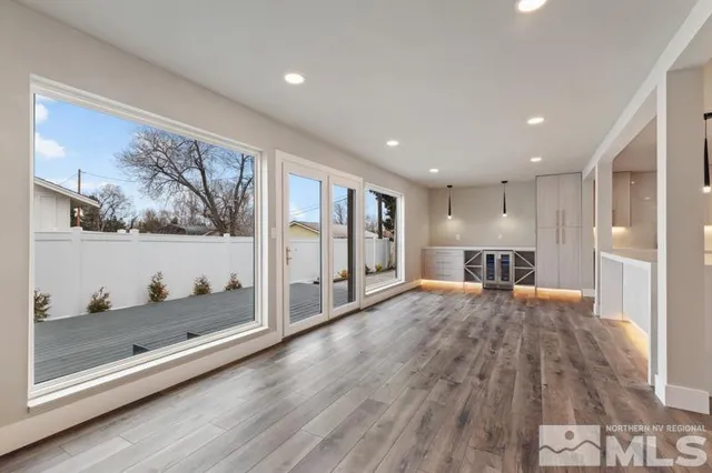a open kitchen with wooden floor and large window