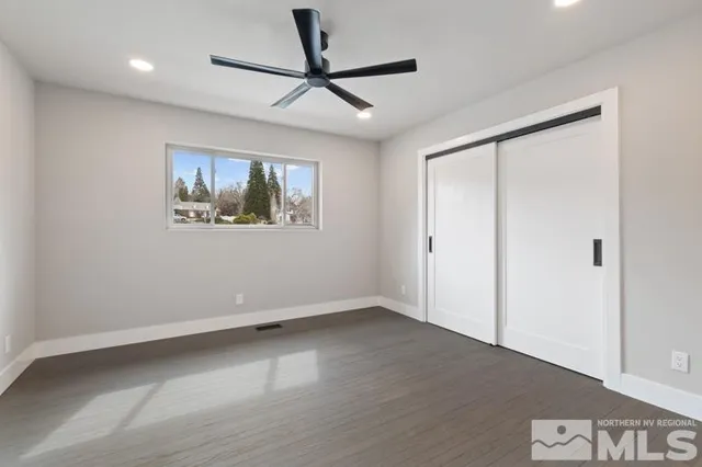 a view of empty room with wooden floor
