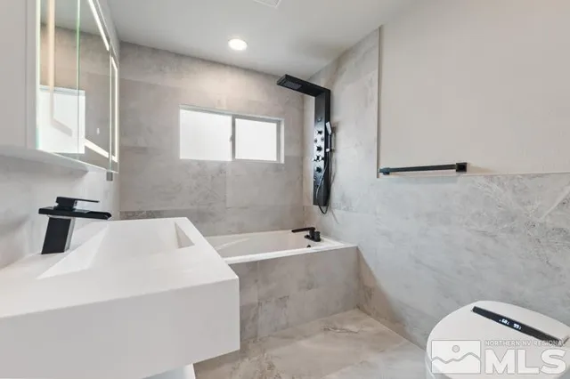 a bathroom with a sink a toilet and tub