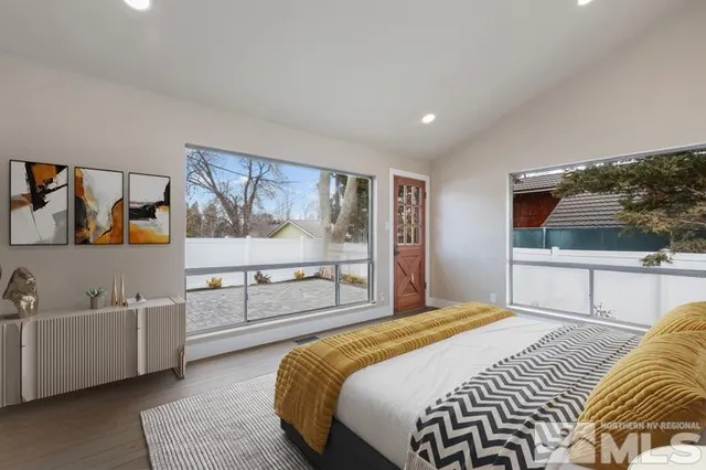 a bedroom with a large bed and a flat screen tv