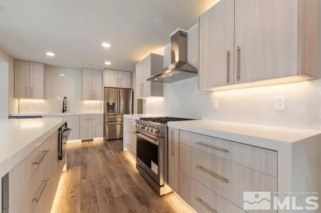 a kitchen with kitchen island a stove a sink and a refrigerator