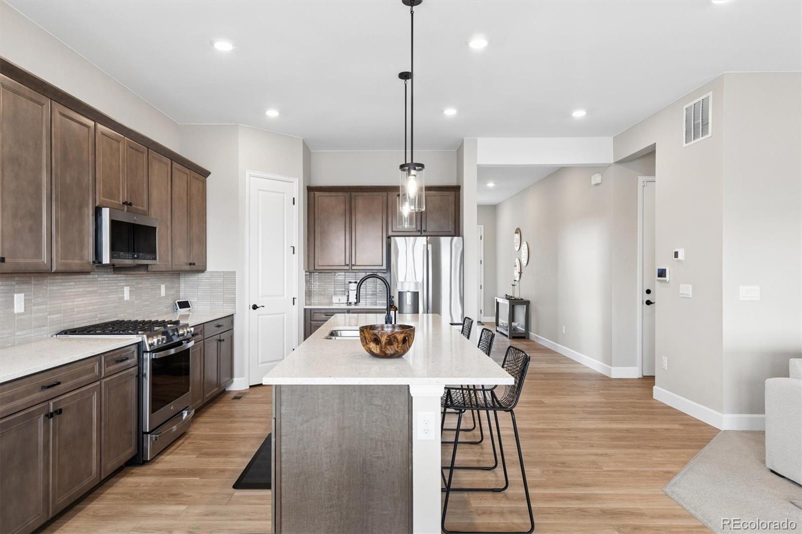 5980 South Platte Canyon Road Littleton, CO 80123 - Photo 14 of 50 a kitchen with stainless steel appliances a stove top oven a refrigerator a sink and dishwasher