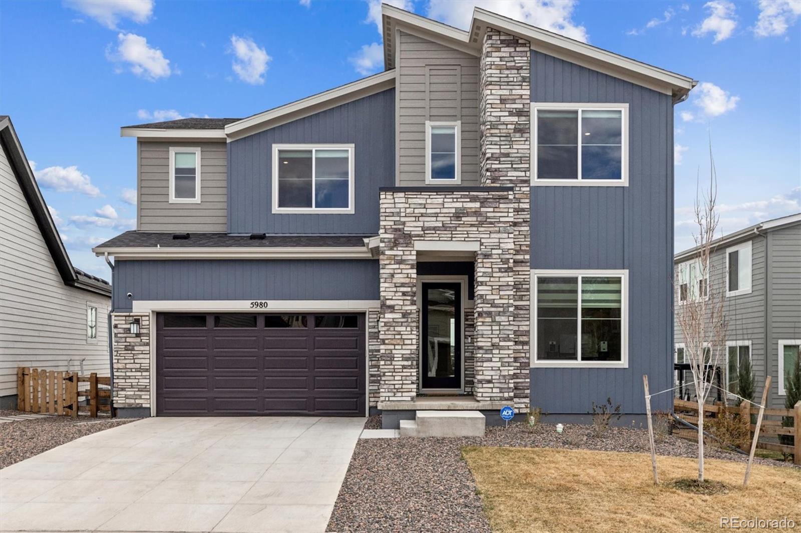 5980 South Platte Canyon Road Littleton, CO 80123 - Photo 2 of 50 a front view of a house with a garage