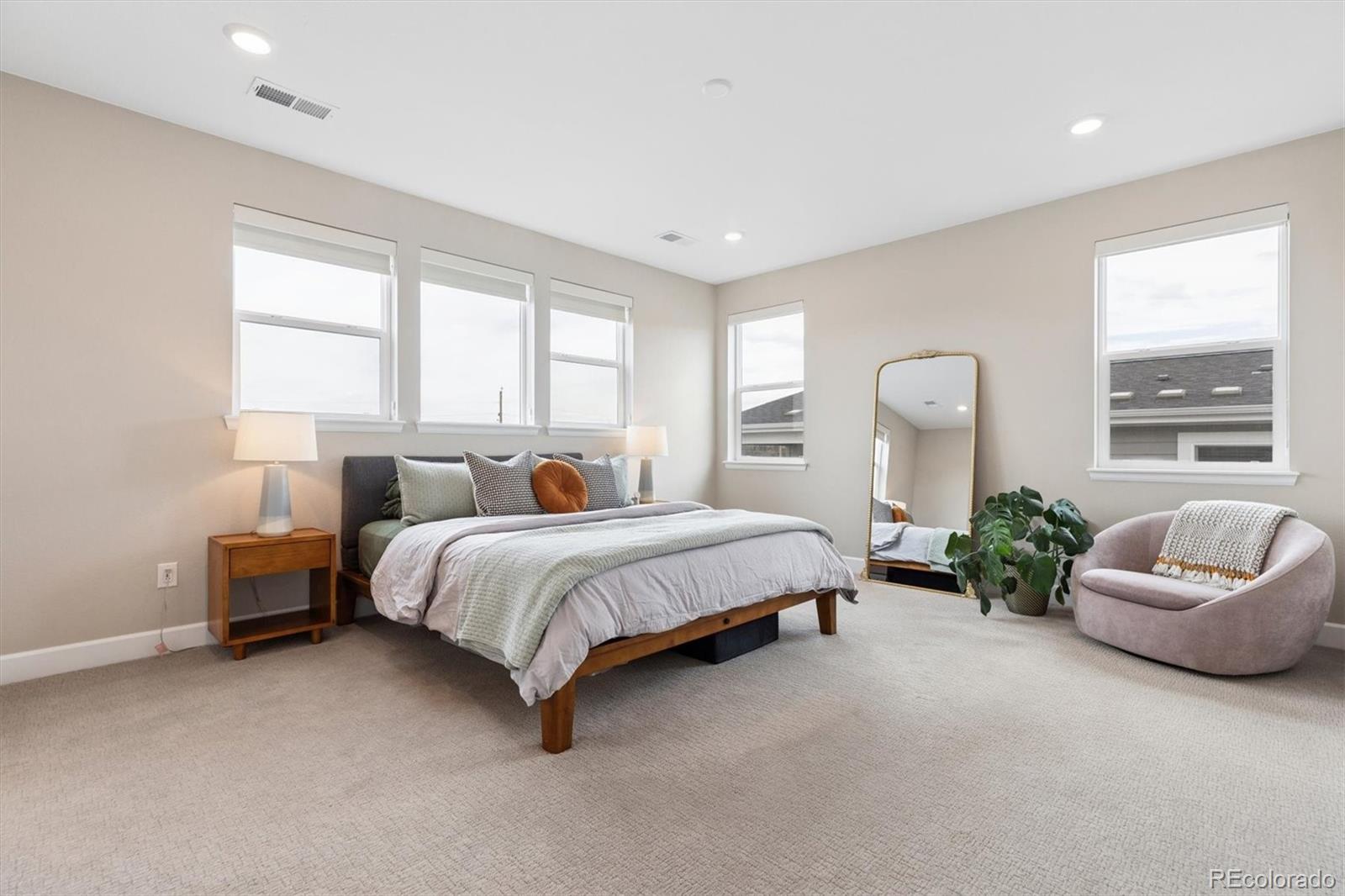 5980 South Platte Canyon Road Littleton, CO 80123 - Photo 27 of 50 a spacious bedroom with a bed and a couch