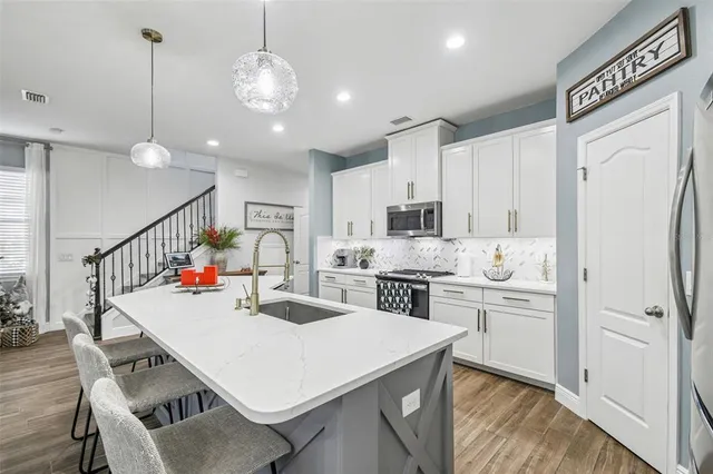 a view of a patio with table and chairs and potted plants