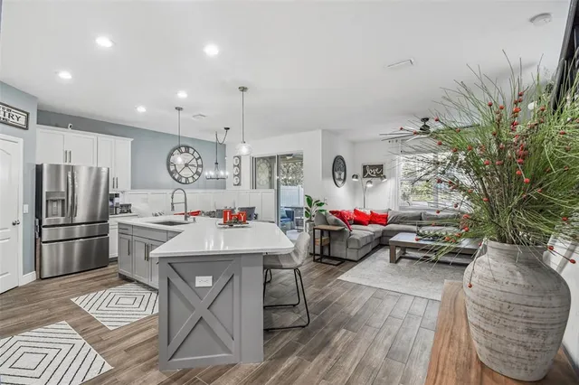 a living room with furniture and a potted plant