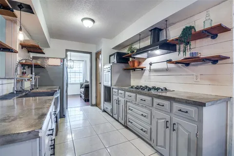a kitchen with stainless steel appliances granite countertop a sink and cabinets