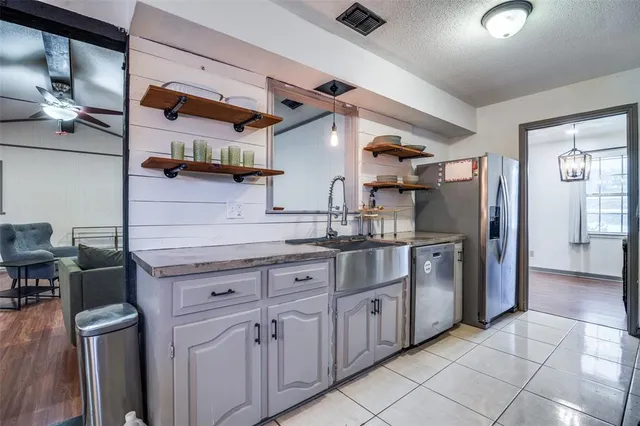 a kitchen with stainless steel appliances granite countertop a sink and cabinets