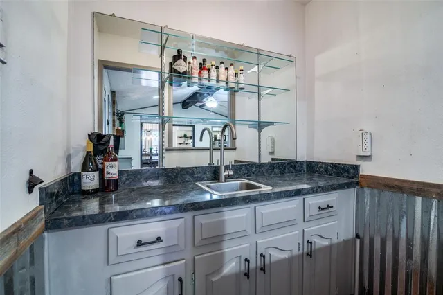 a kitchen with granite countertop a sink and cabinets