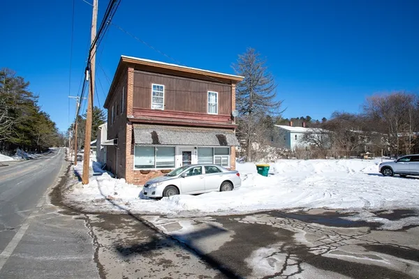 a front view of a house with snow on roof