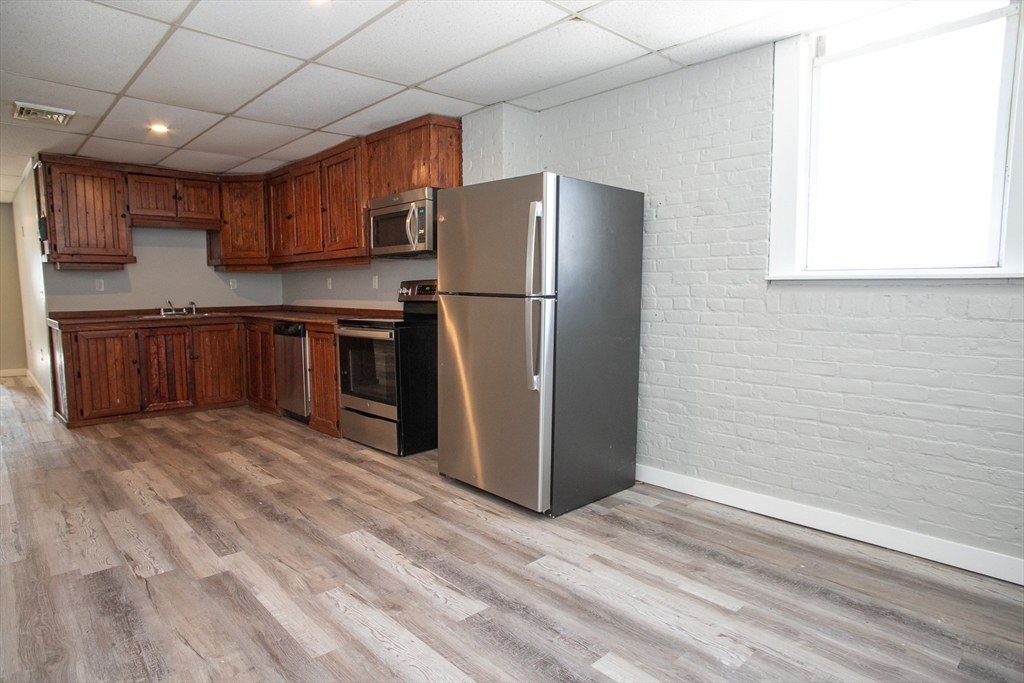 865 South Barre Road Barre, MA 01074 - Photo 23 of 34 a kitchen with stainless steel appliances granite countertop a refrigerator a stove and a sink with wooden floor