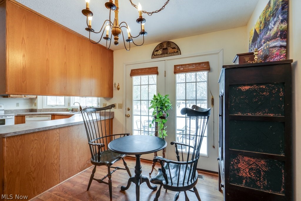 136 Taylor Road Barberton, OH 44203 - Photo 15 of 45 Dining room featuring light wood-style flooring and a chandelier