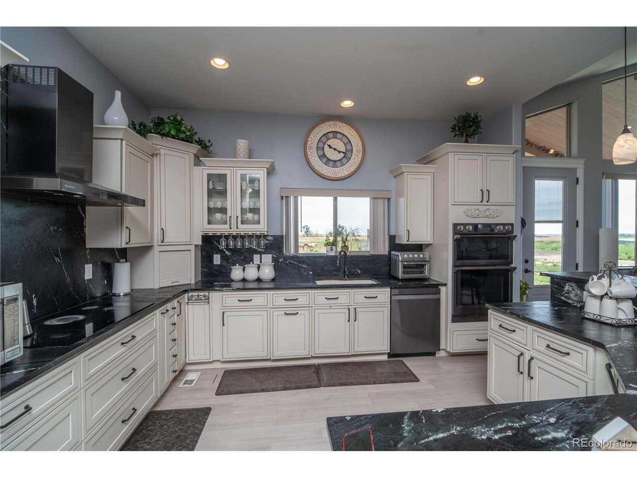 9368 41st Fort Fort Lupton, CO 80621 - Photo 12 of 44 a kitchen with stainless steel appliances granite countertop a stove and cabinets
