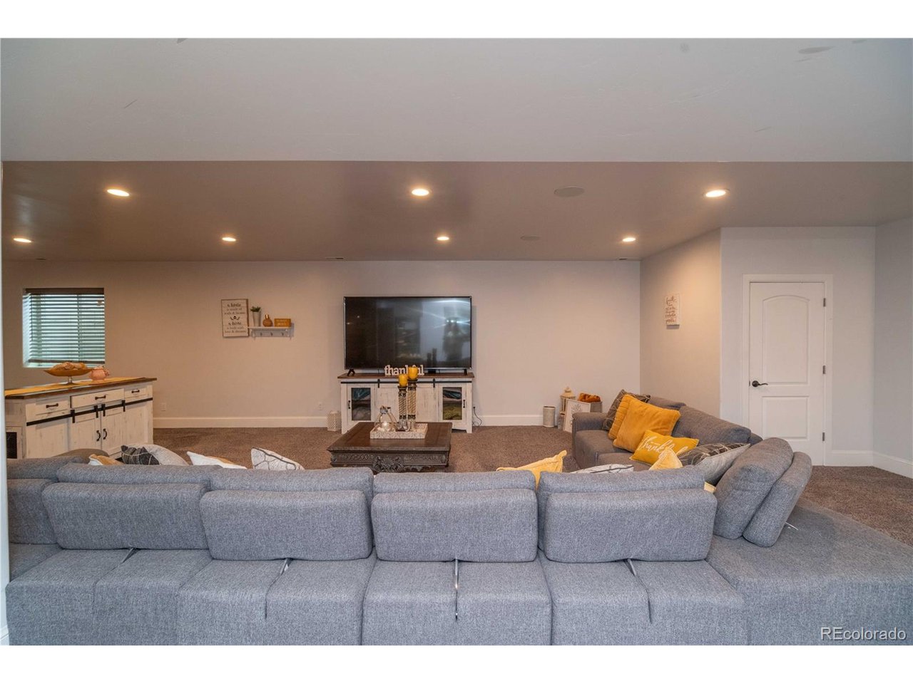 9368 41st Fort Fort Lupton, CO 80621 - Photo 18 of 44 a living room with furniture and a flat screen tv