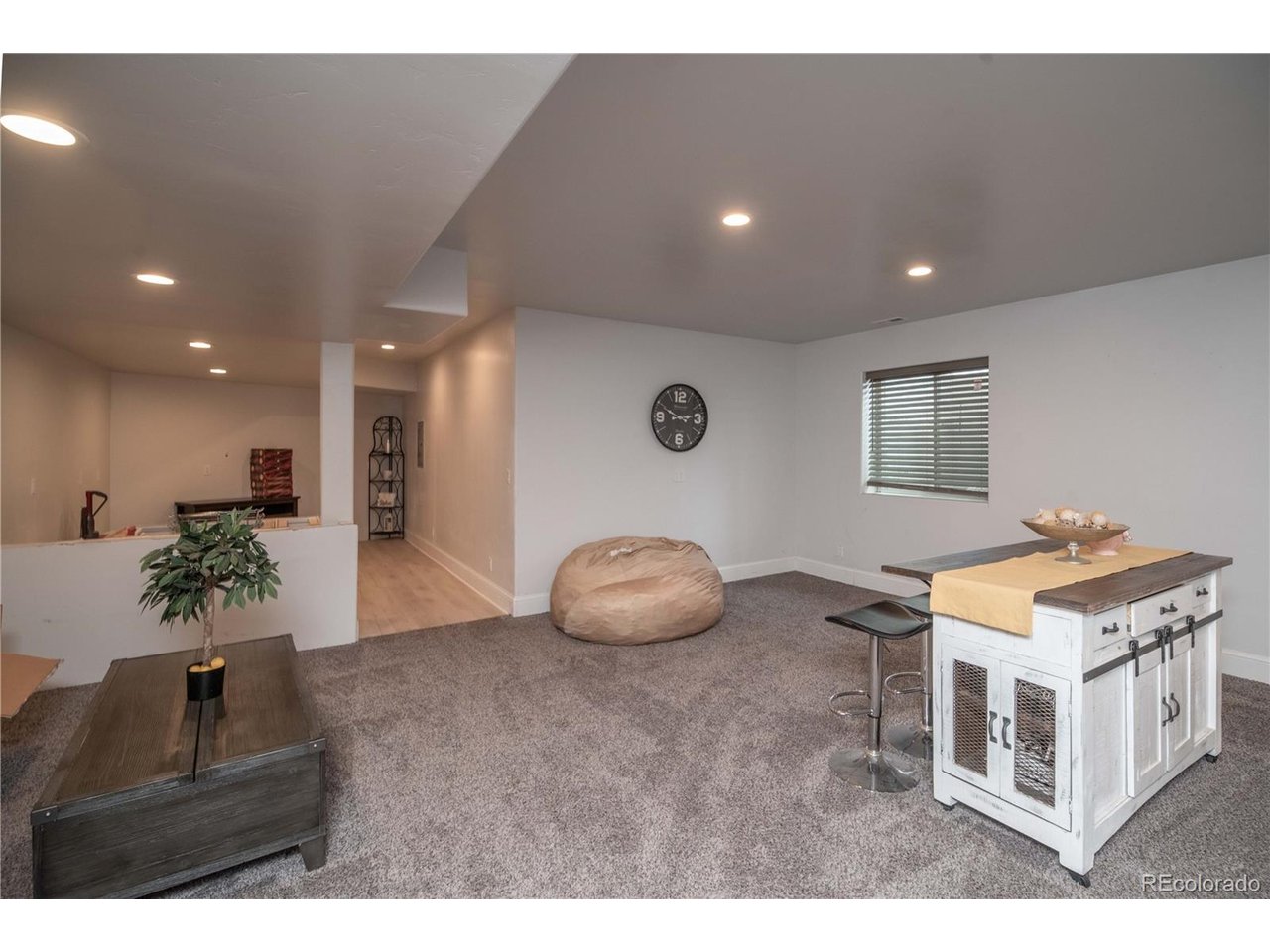 9368 41st Fort Fort Lupton, CO 80621 - Photo 19 of 44 a living room with furniture and a table