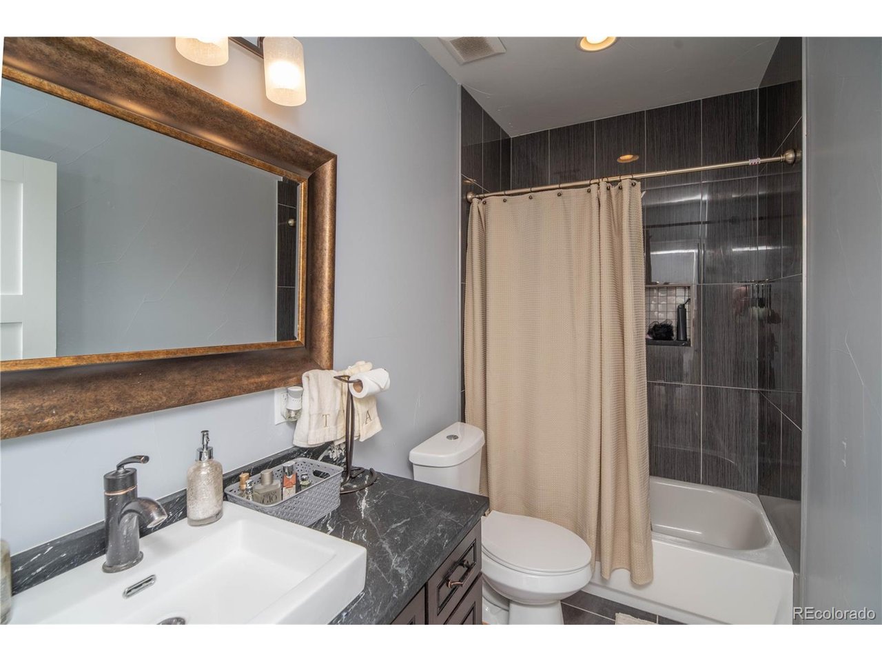 9368 41st Fort Fort Lupton, CO 80621 - Photo 21 of 44 a bathroom with a sink toilet and shower