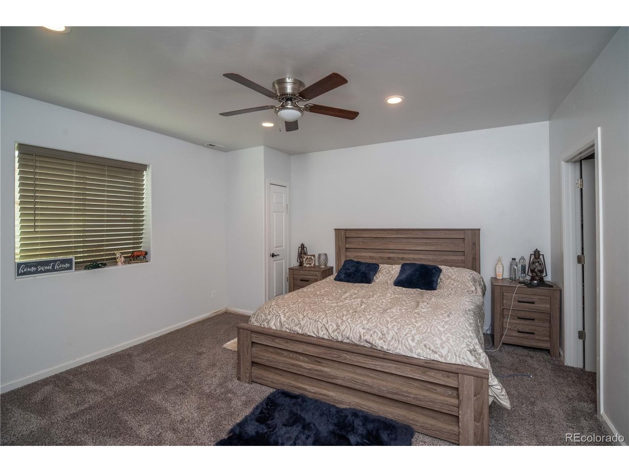 9368 41st Fort Fort Lupton, CO 80621 - Photo 23 of 44 a bedroom with a bed and a chandelier