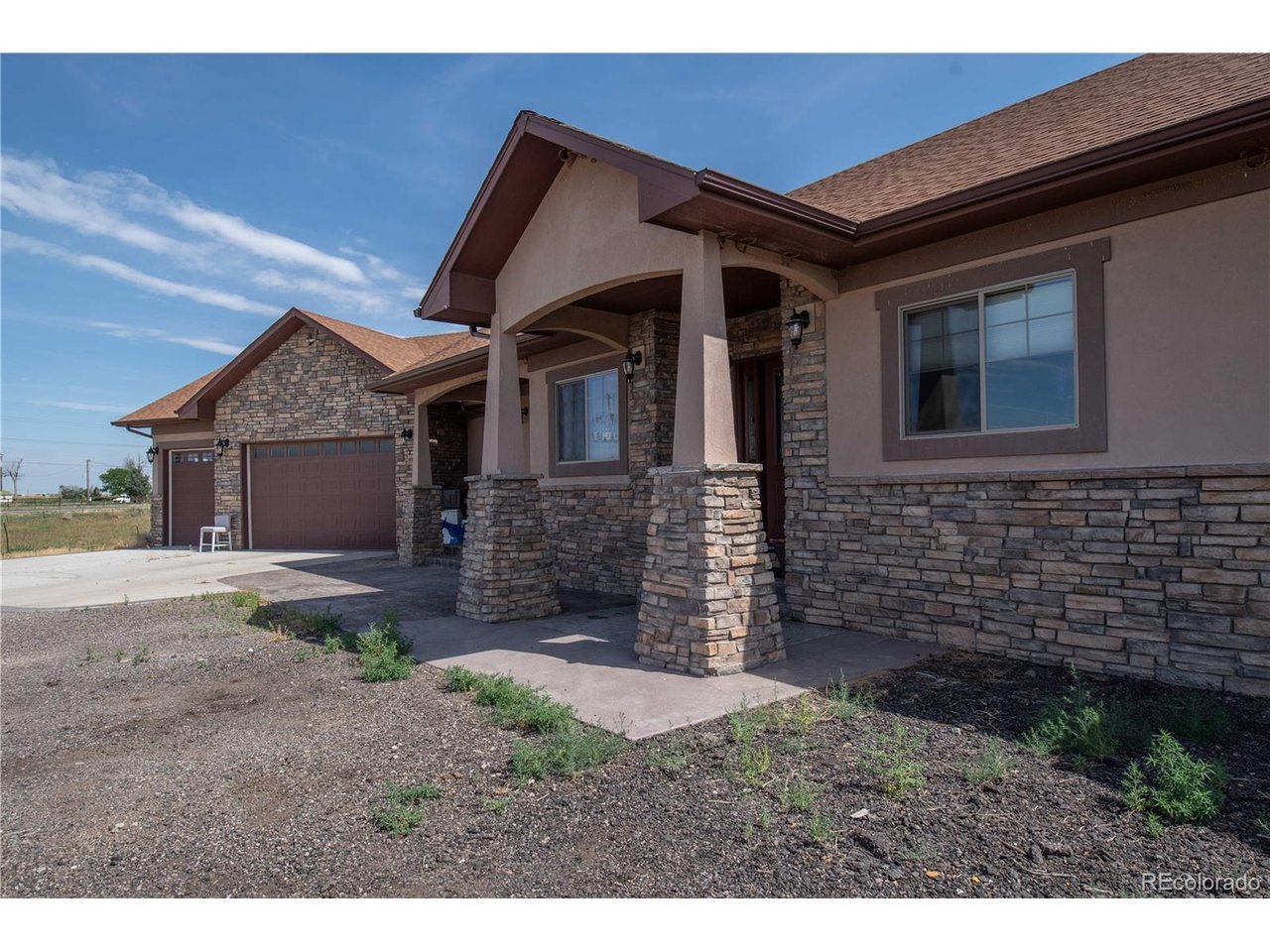 9368 41st Fort Fort Lupton, CO 80621 - Photo 3 of 44 a front view of a house with a yard