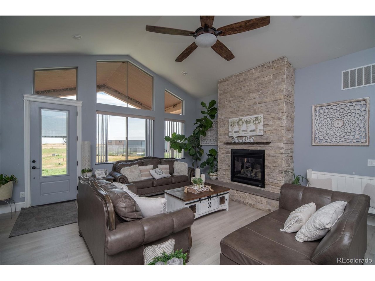 9368 41st Fort Fort Lupton, CO 80621 - Photo 5 of 44 a living room with furniture and a fireplace