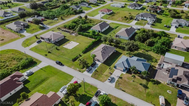 an aerial view of multiple houses with yard