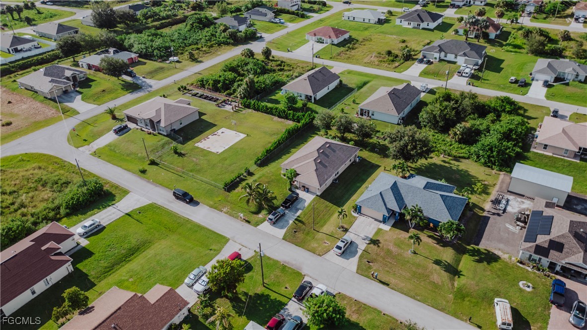an aerial view of multiple houses with yard