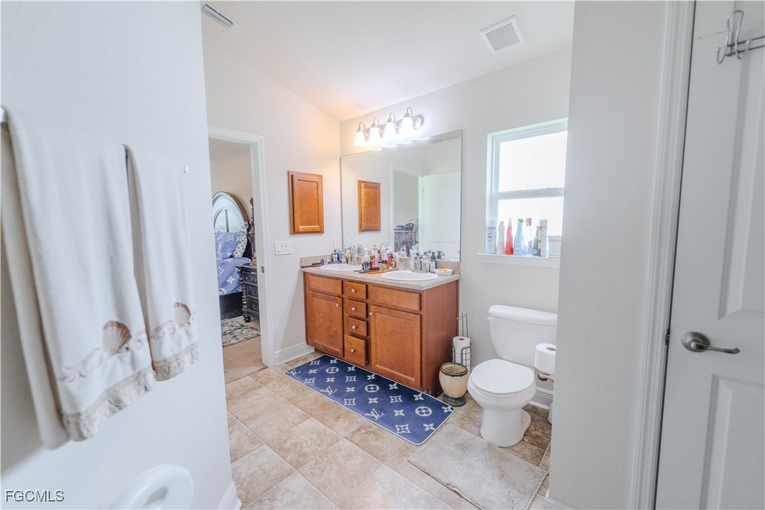 5134 Baron Street Lehigh Acres, FL 33971 - Photo 11 of 30 a bathroom with a sink toilet and shower