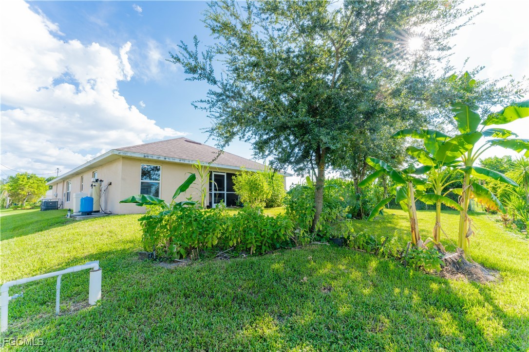 5134 Baron Street Lehigh Acres, FL 33971 - Photo 14 of 30 a front view of house with yard and green space