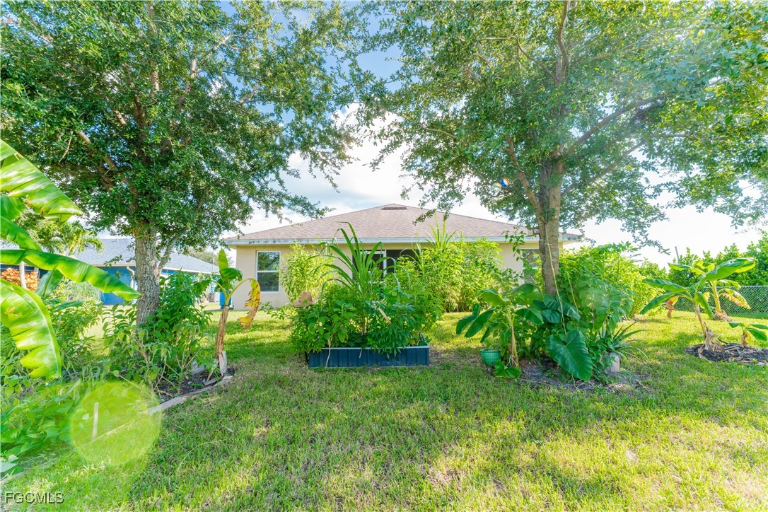5134 Baron Street Lehigh Acres, FL 33971 - Photo 15 of 30 a view of a garden with plants
