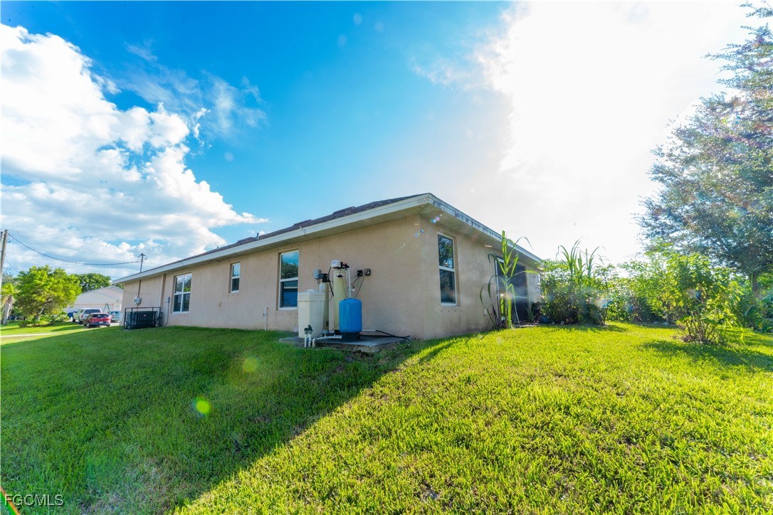 5134 Baron Street Lehigh Acres, FL 33971 - Photo 17 of 30 a view of a house with a yard