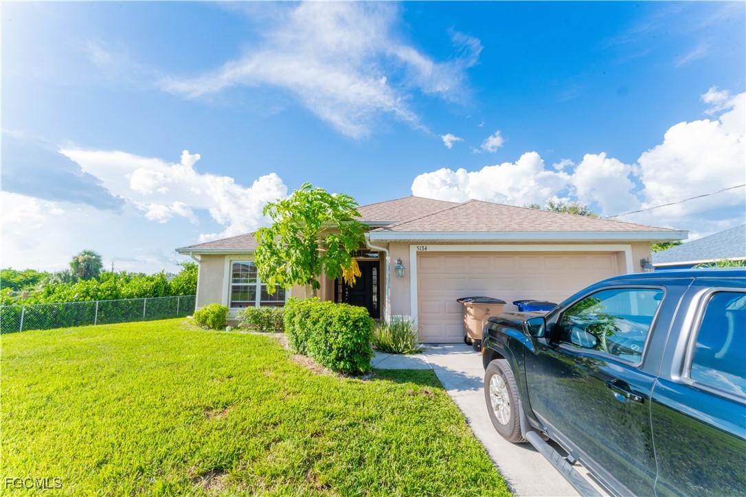 5134 Baron Street Lehigh Acres, FL 33971 - Photo 19 of 30 a view of house with outdoor space and entertaining space
