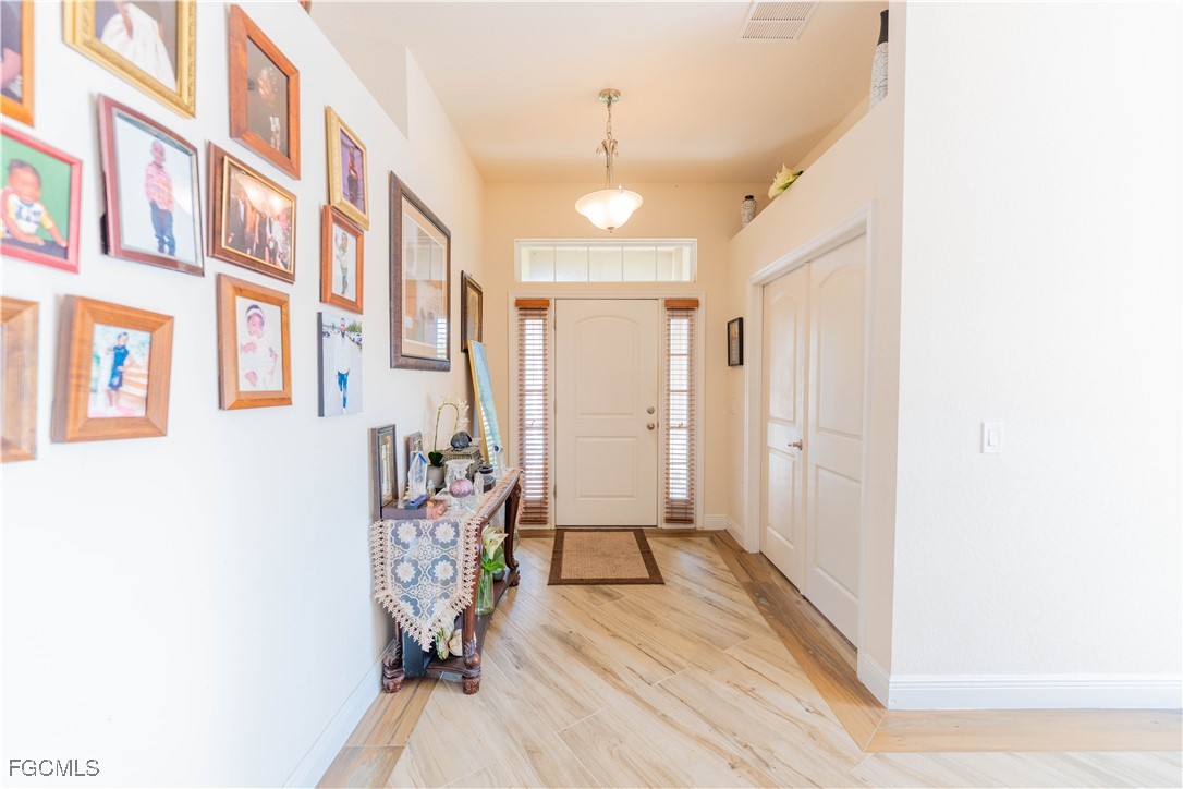 5134 Baron Street Lehigh Acres, FL 33971 - Photo 2 of 30 a view of an entryway with wooden floor