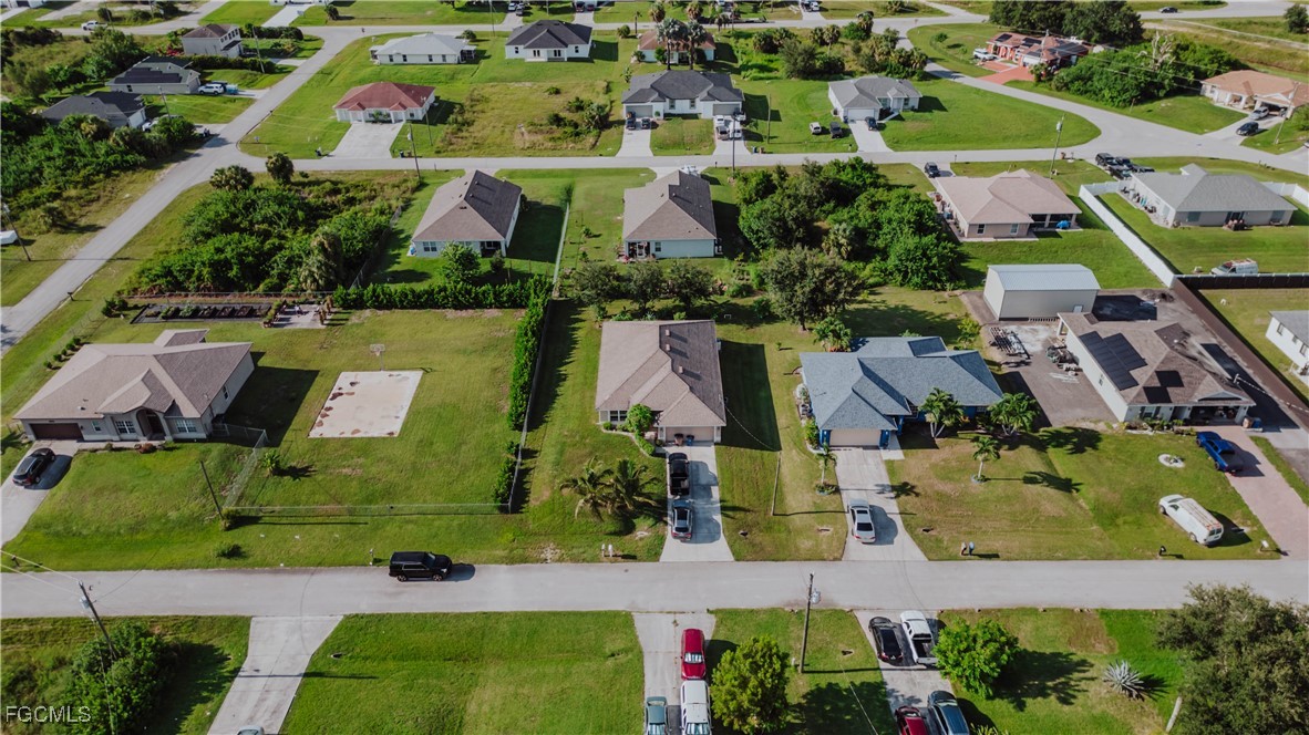 5134 Baron Street Lehigh Acres, FL 33971 - Photo 27 of 30 an aerial view of house with yard swimming pool and outdoor seating
