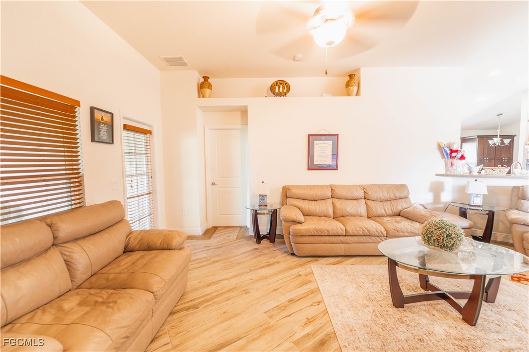 5134 Baron Street Lehigh Acres, FL 33971 - Photo 6 of 30 a bedroom with a bed and a couch