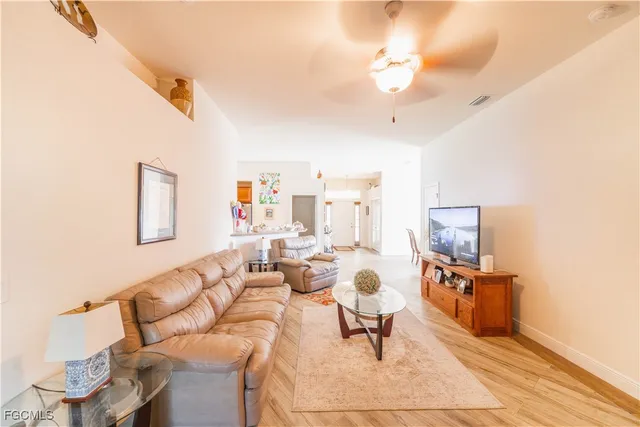 a living room with furniture and a chandelier