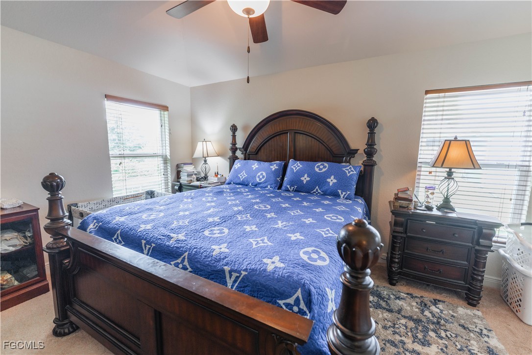 5134 Baron Street Lehigh Acres, FL 33971 - Photo 8 of 30 a bedroom with a bed and a dresser next to window