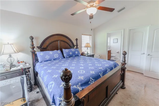 a bedroom with a bed and a ceiling fan