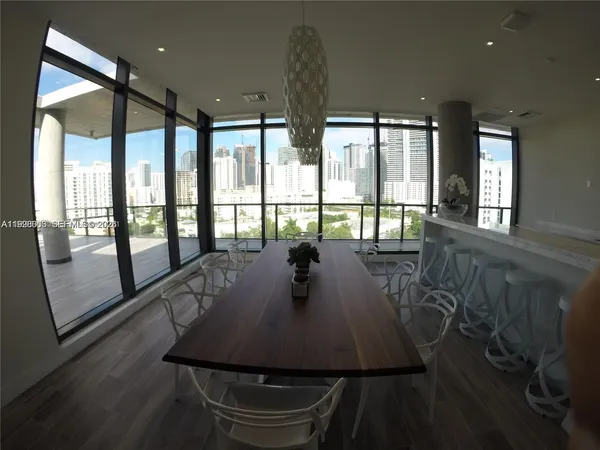 a living room with hard wood floors and a table