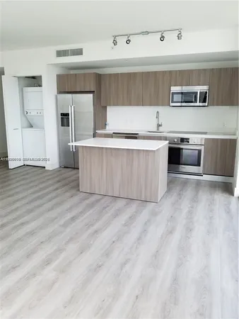 a kitchen with stainless steel appliances a stove top oven and cabinets