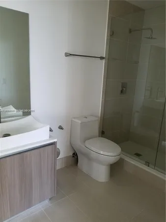 a white toilet sitting next to a bathroom sink