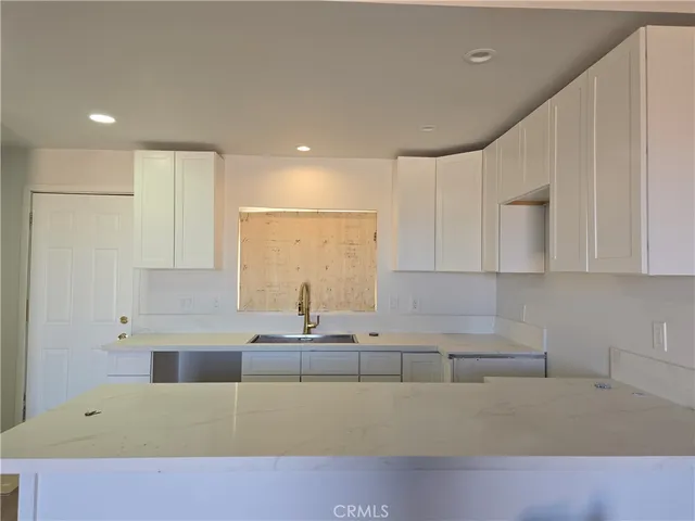 a kitchen with a sink cabinets and window