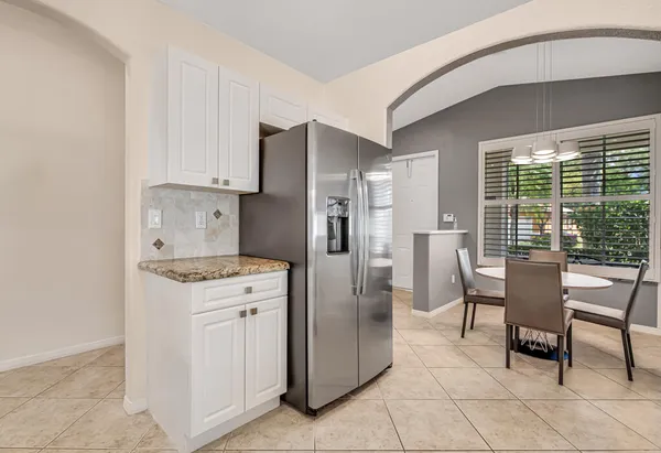 a kitchen with stainless steel appliances granite countertop a refrigerator and a stove top oven