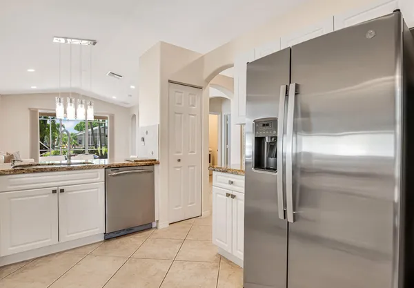 a kitchen with stainless steel appliances granite countertop a refrigerator and a sink