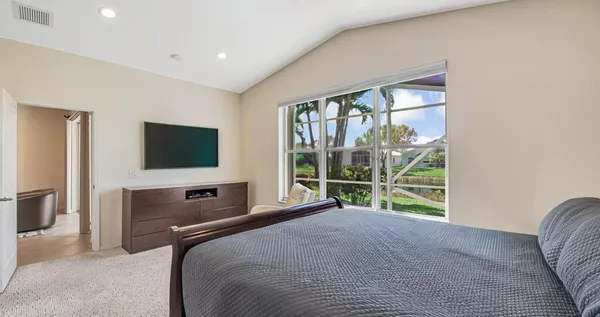a bedroom with a bed and a television