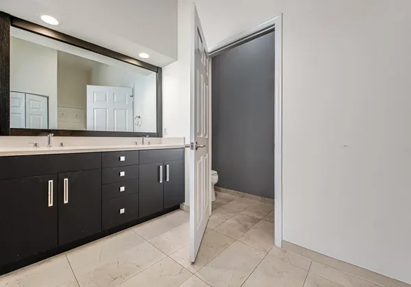 a spacious bathroom with a mirror sink and vanity