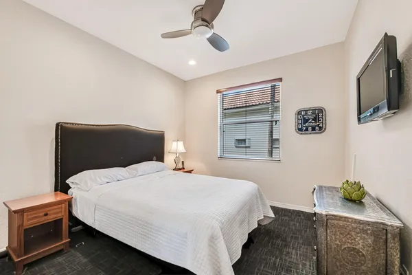 a bedroom with a bed and a flat screen tv