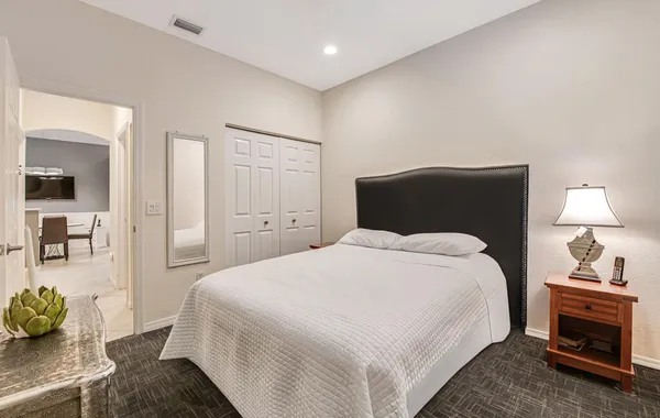 a bedroom with a bed and a couch