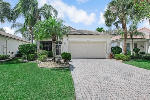 a front view of a house with a yard and a garage