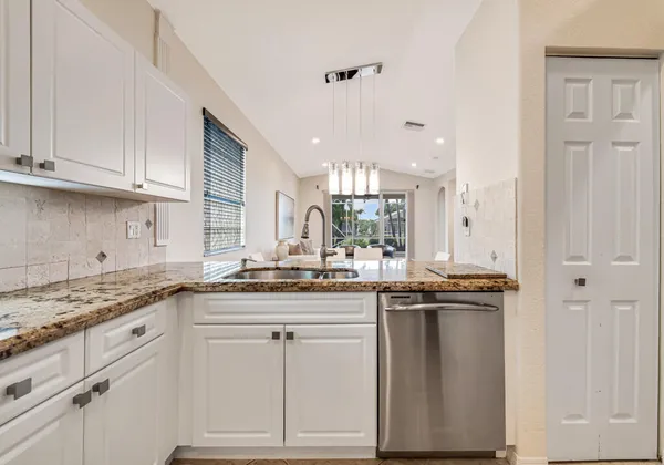 a kitchen with stainless steel appliances granite countertop a sink and cabinets