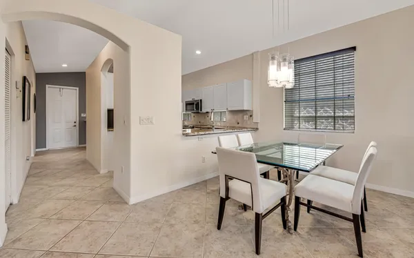 a dining room with furniture and window